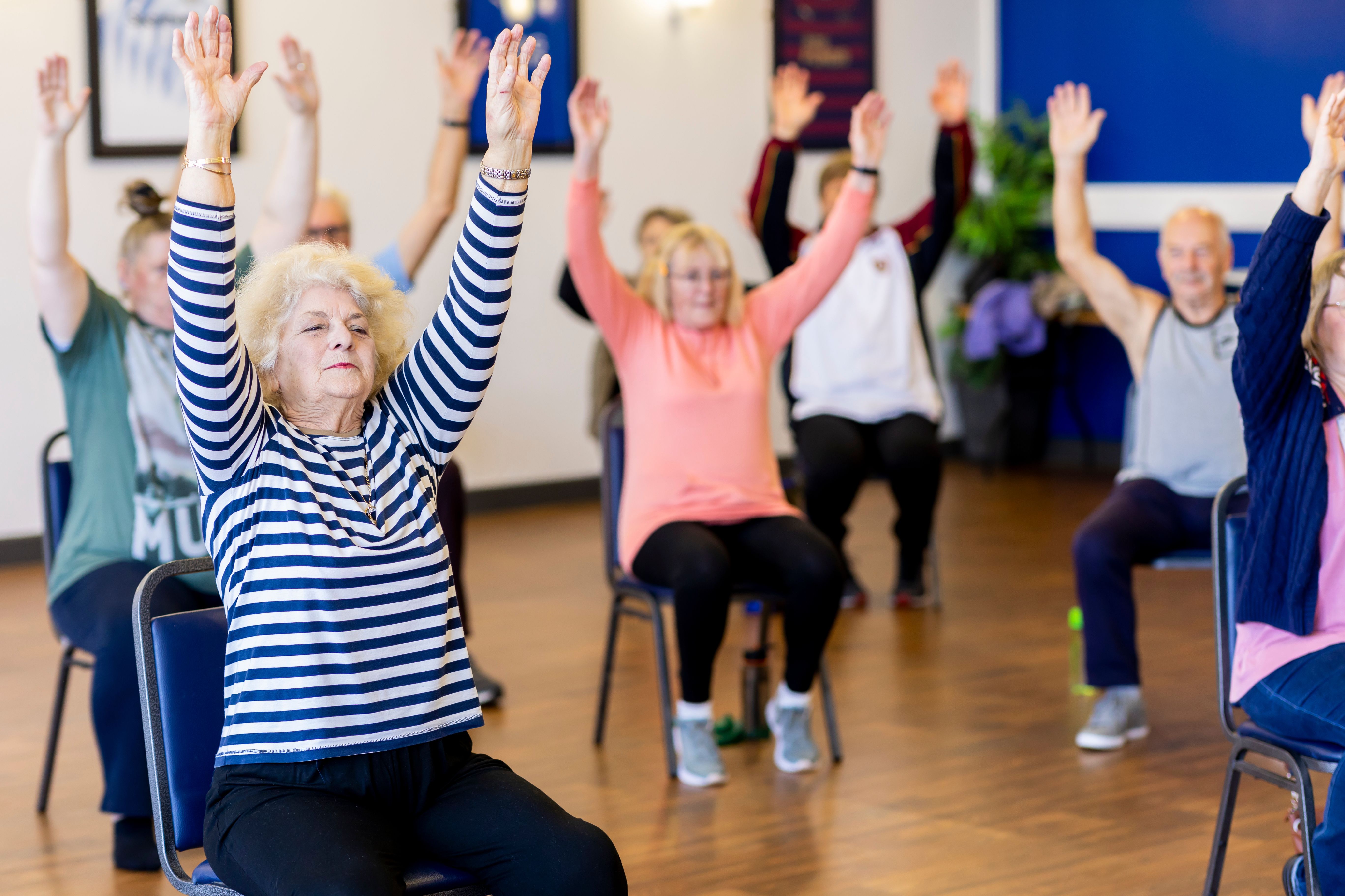 group of senior citizens seated in an excercise class